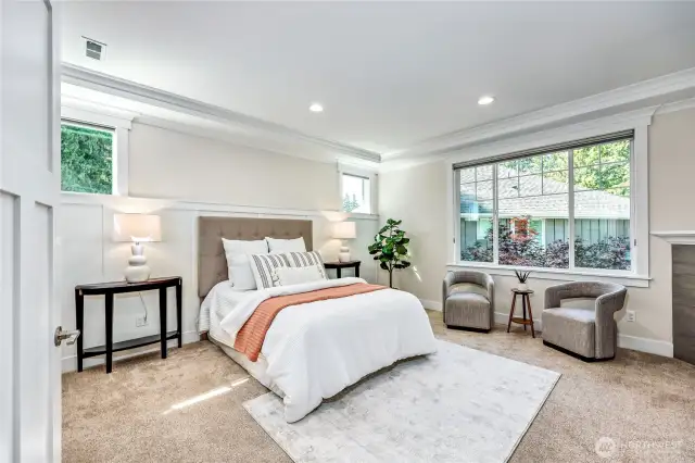 The large primary suite boasts a second fireplace, a 5-piece en-suite, and two closets.