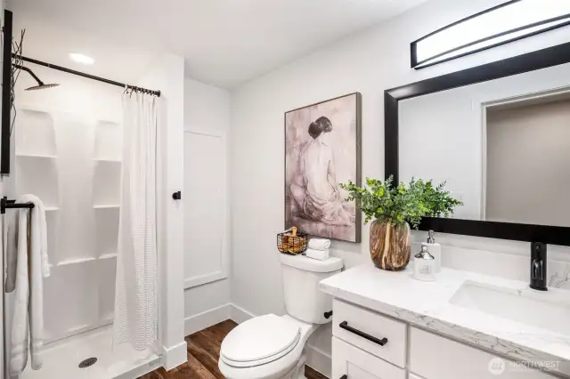 Lower level 3/4 shower with extra wall storage.
