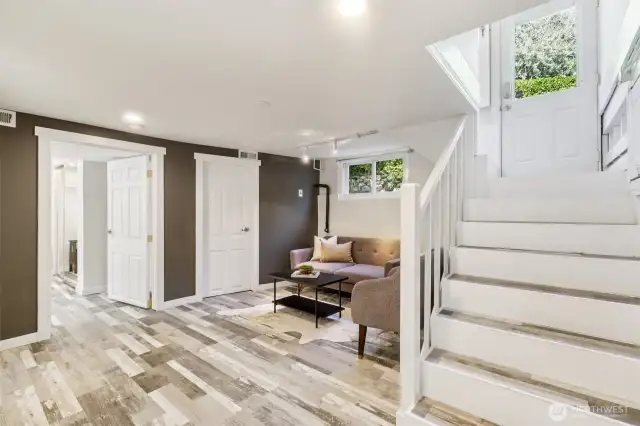 Lower level bonus/family area.  Stairs lead to the kitchen and access to the back deck