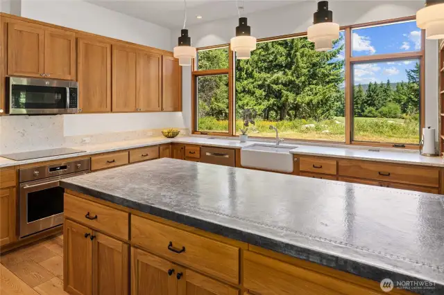 Quartz counters surround the kitchen with hickory custom cabinets. The microwave also is a double oven.