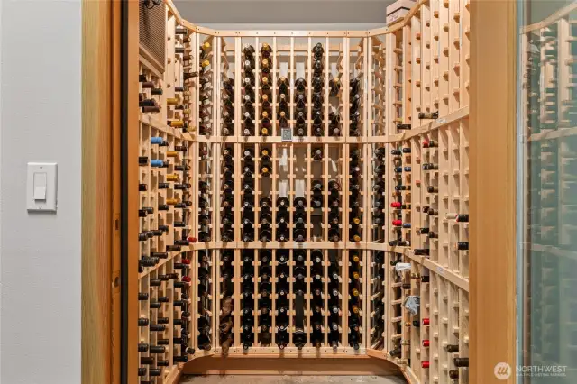 The wine cellar is located in the garage and cooled to 57 degrees and accommodates 300 bottles. Cheers!