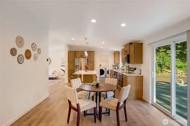 Bright dining area with slider leading to outdoor living