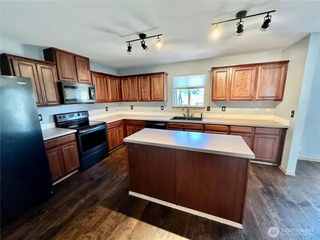 Large kitchen complete with island, all appliances stay, loads of cabinets and huge pantry/laundry room.