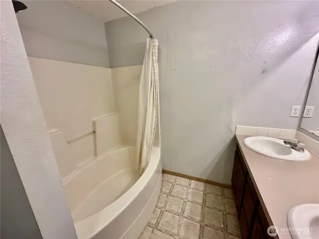 Anther view of the primary bath with double sinks and tub/shower combo.
