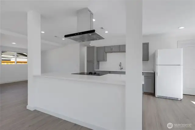 Laundry room is to the right of the fridge.
