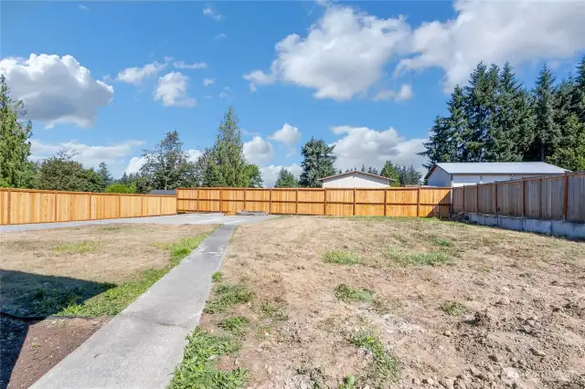 Another look at the spacious back yard and fire pit area.
