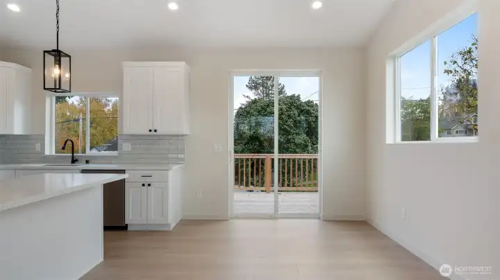 Eating space off of kitchen has deck access.