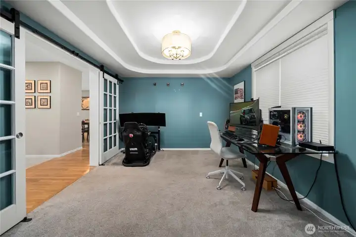 Formal dining with layered tray ceiling. Currently being used as office.