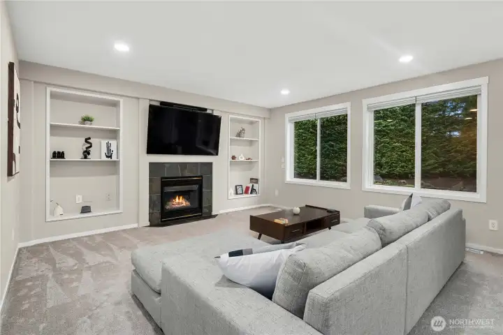 Great room with gas fireplace and built-in shelves.