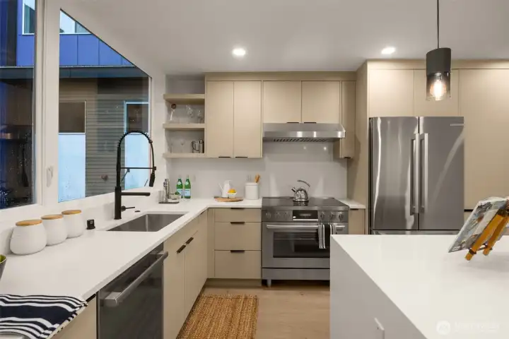 The kitchen features a 6-burner cooking range- ready for the at-home professional chef