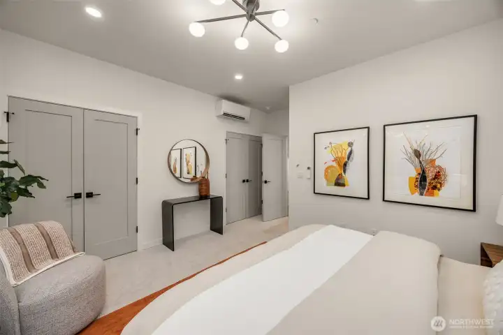 Modern light fixtures coupled with the large windows keep the room bright, while the mini-split offers full climate control