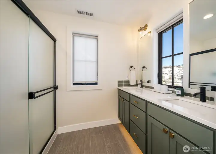 Primary Bath: Accent lighting, Cedar & Moss® designer accent lighting, framed mirrors & a stylish vanity & custom backsplash.