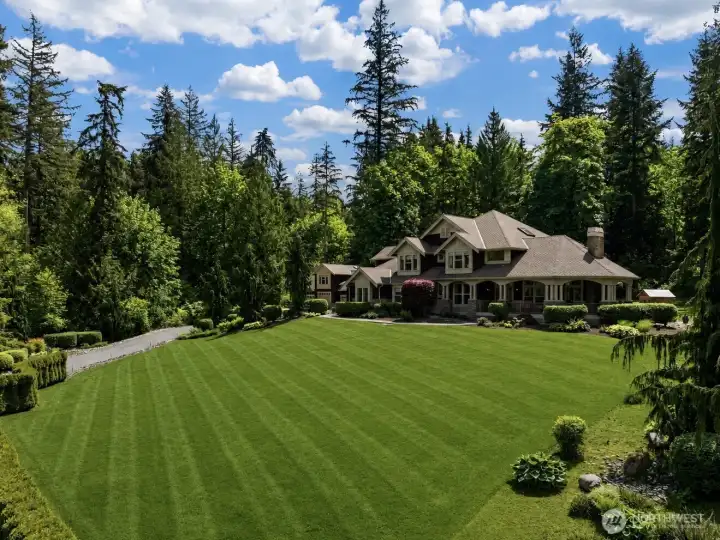 You're going to love this Premier home in Woodinville on over 5 acres! 4 bedrooms plus guest suite,  5.5 bathrooms, 6 car garage, detached studio, sauna, hot tub, cold plunge, fire pit, basketball court, covered patio with pizza oven & fireplace, wooded trails, & more!