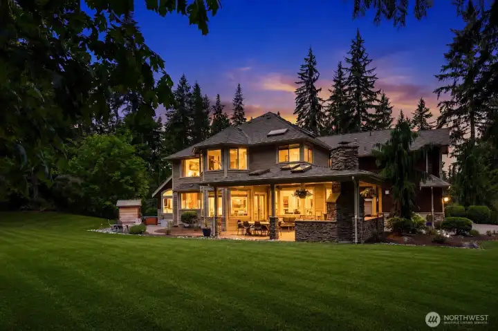 Lush landscaping surrounds this custom home built for entertaining and enjoying the outdoors year-round. Lush landscaping surrounds this custom home built for entertaining and enjoying the outdoors year-round.