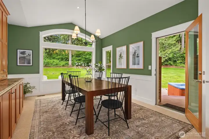 Dining area with built-in china cabinet and serving area, plus access door to the cold plunge, hot tub, and sauna. Dining area with built-in china cabinet and serving area, plus access door to the cold plunge, hot tub, and sauna.