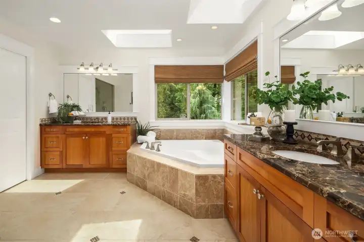 Welcome to the en-suite primary bath with double vanities, sunken tub, heated flooring, granite countertops, and privacy shades. Welcome to the en-suite primary bath with double vanities, sunken tub, heated flooring, granite countertops, and privacy shades.