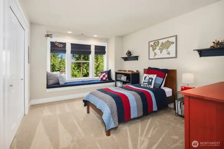 One of the three additional bedrooms (other than the primary) on the upper floor. All bedrooms offer extra space, window seats with storage, and direct access to a bathroom. One of the three additional bedrooms (other than the primary) on the upper floor. All bedrooms offer extra space, window seats with storage, and direct access to a bathroom.