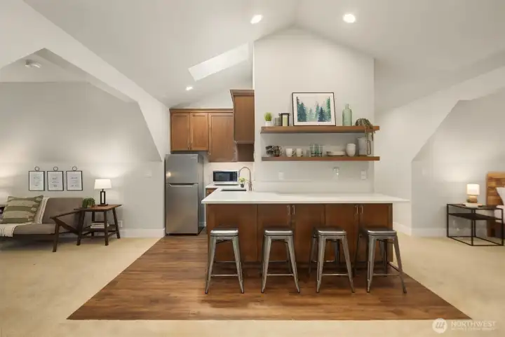Private studio space above the detached garage offers bar seating and kitchenette with fridge and microwave. This additional space is perfect for guests, entertaining, work-from-home office, or multi-generational living. Private studio space above the detached garage offers bar seating and kitchenette with fridge and microwave. This additional space is perfect for guests, entertaining, work-from-home office, or multi-generational living.
