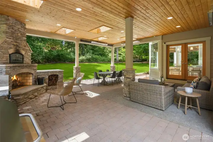 Another view of the covered patio showing multiple sitting areas, wood storage, fireplace, pizza oven, heaters, and drop down movie screen. Imagine the memories that will be made here... Another view of the covered patio showing multiple sitting areas, wood storage, fireplace, pizza oven, heaters, and drop down movie screen. Imagine the memories that will be made here...