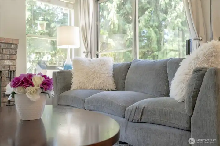 Living room overlooks large, fenced yard.
