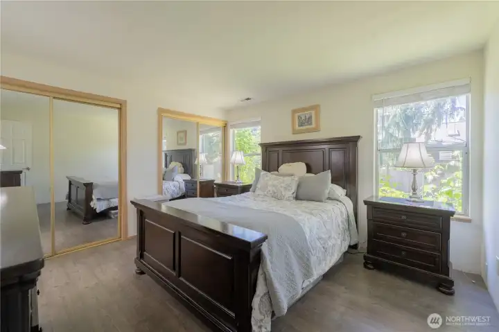 Spacious primary suite overlooks peaceful yard.