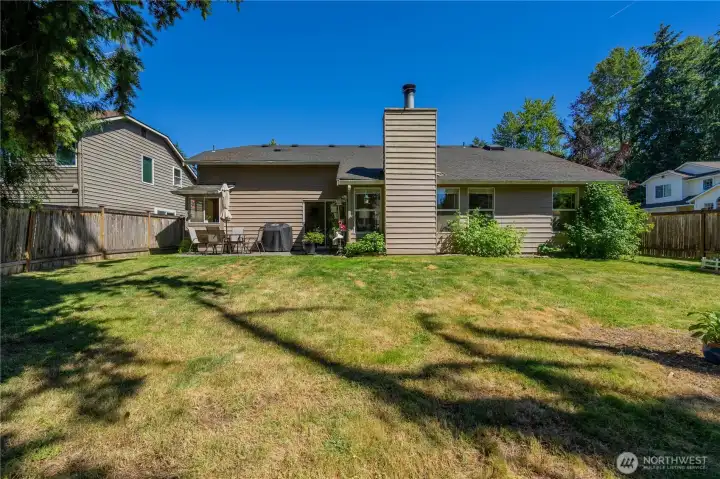 Back exterior overlooks large, fully fenced yard.