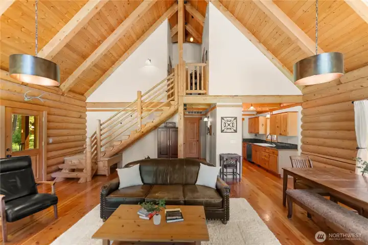 Soaring vaulted ceilings and handcrafted log construction.