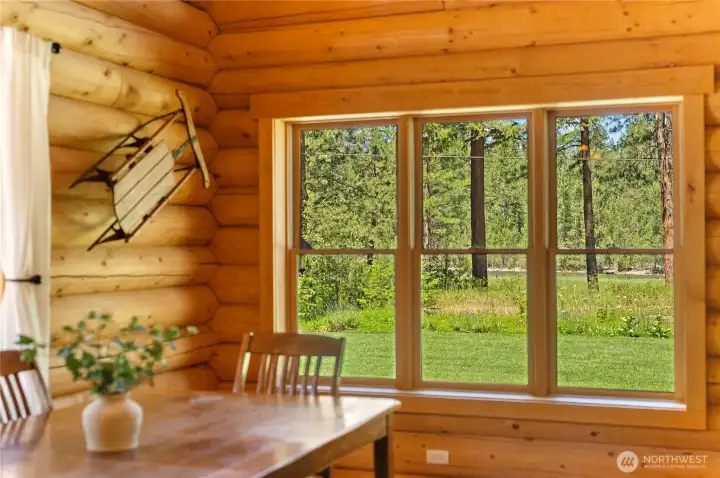 Large windows frame river and mountain views year-round.