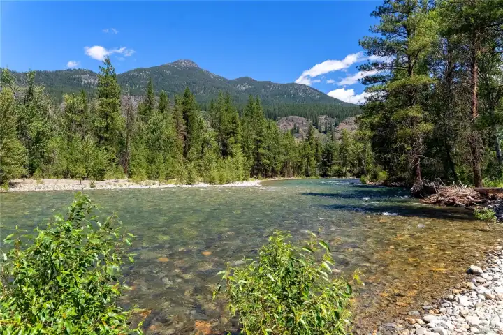 Crystal-clear Methow River waters flow beneath the dramatic backdrop of Goat Peak.