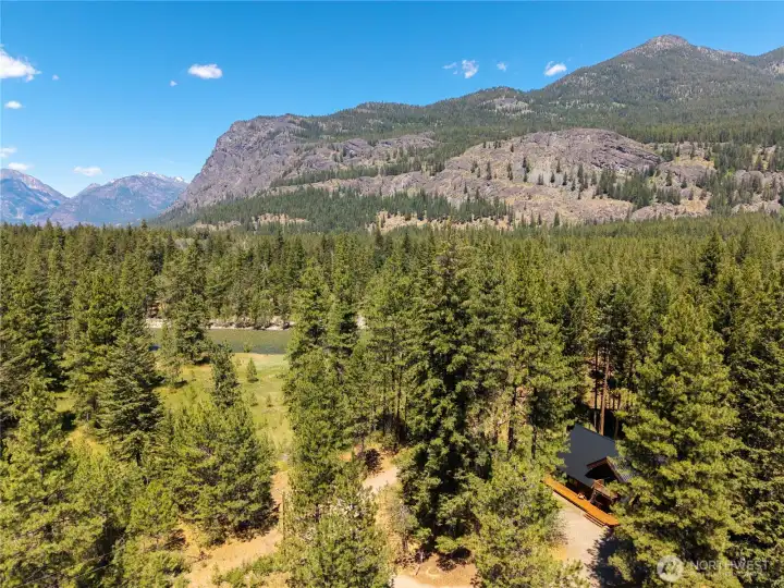Luxury log home ownership in Mazama Pines with iconic Goat Wall views, community riverfront access, and year-round recreation at your doorstep.
