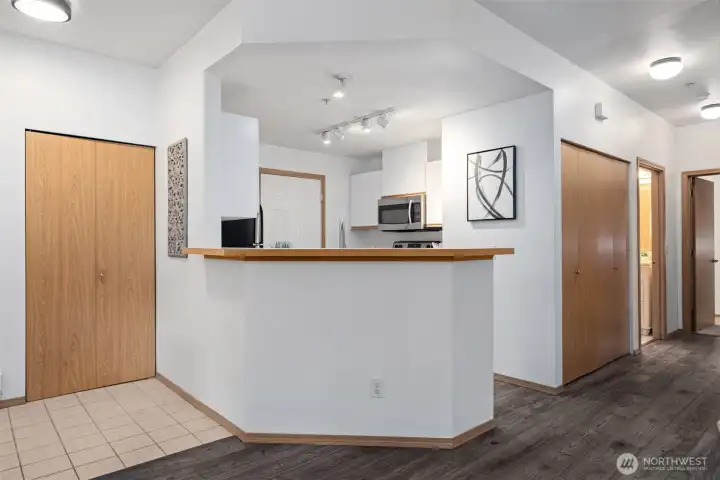 Looking into the kitchen and at the coat closet by the door.