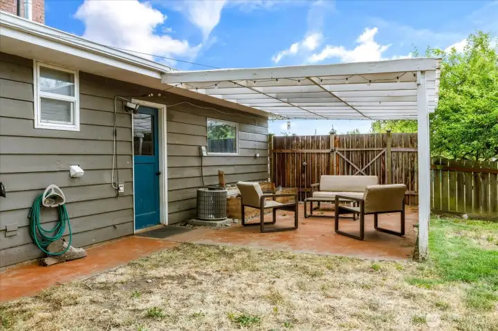 Covered patio provides a comfortable outdoor space for relaxing and entertaining.