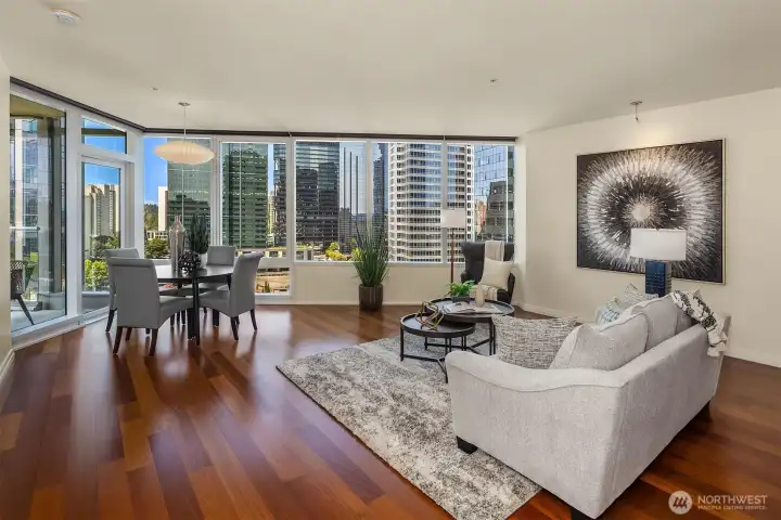 The living and dining space is wrapped in floor-to-ceiling windows, topped with motorized blinds for privacy at the touch of a button. The living and dining space is wrapped in floor-to-ceiling windows, topped with motorized blinds for privacy at the touch of a button.