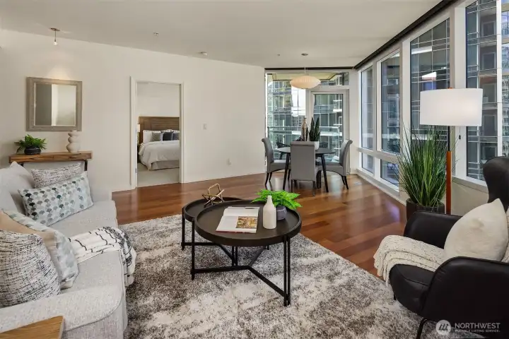 Another look at the living and dining space highlights the room's generous proportions, with a covered balcony just beyond the dining table. Another look at the living and dining space highlights the room's generous proportions, with a covered balcony just beyond the dining table.