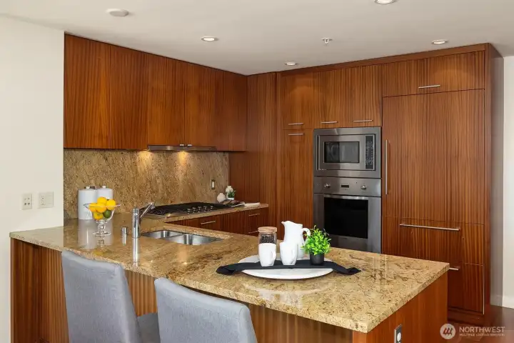 The kitchen features Paladore granite countertops paired with premium, sleek paneled appliances and a pantry. The kitchen features Paladore granite countertops paired with premium, sleek paneled appliances and a pantry.