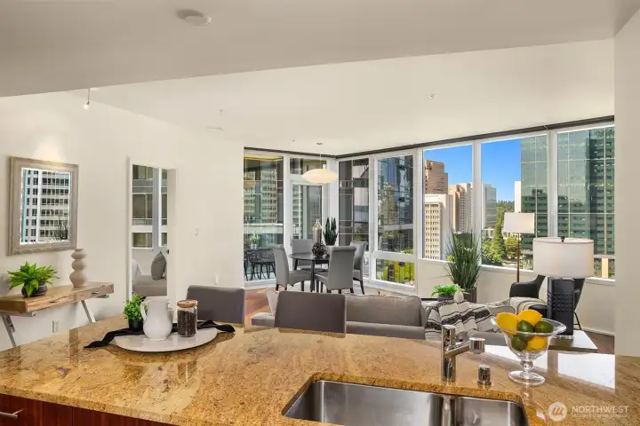 The open-concept living space captures sweeping views of the Bellevue skyline through walls of glass. The open-concept living space captures sweeping views of the Bellevue skyline through walls of glass.