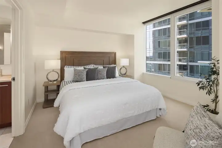 The primary bedroom is bathed in natural light and equipped with electric blinds for effortless privacy. The primary bedroom is bathed in natural light and equipped with electric blinds for effortless privacy.