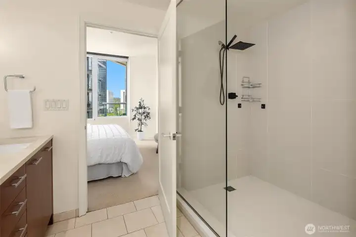 A spacious glass walk-in shower with a rainfall showerhead. A spacious glass walk-in shower with a rainfall showerhead.