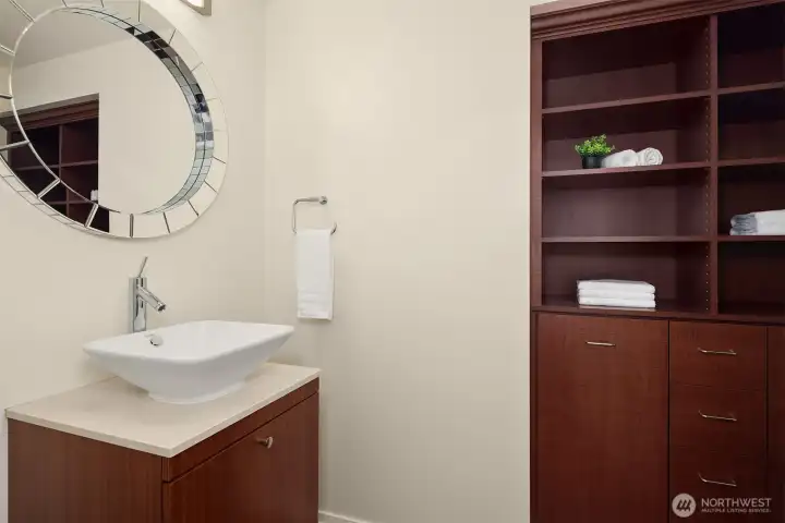 The stylish powder room is well appointed with custom built-in storage. The stylish powder room is well appointed with custom built-in storage.