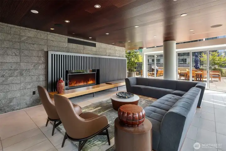 The recently remodeled resident great room lounge features a cozy fireplace, perfect for gatherings, along with a dining table and chairs and a large TV in an adjacent area. This space, along with a private dining room and theater, is available to rent. The recently remodeled resident great room lounge features a cozy fireplace, perfect for gatherings, along with a dining table and chairs and a large TV in an adjacent area. This space, along with a private dining room and theater, is available to rent.