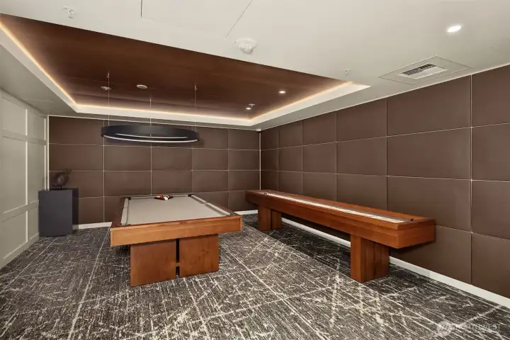 Just off the great room, a game room offers a pool table and shuffleboard for casual fun. Just off the great room, a game room offers a pool table and shuffleboard for casual fun.