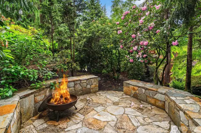 Flagstone veranda for firepit with beautiful lush surroundings