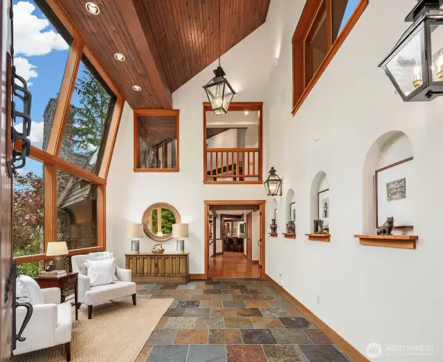 2-story glass atrium designed by Greg Bader. 20' plus ceilings. Multicolor slate tile floor. Arched art nooks and custom lighting.