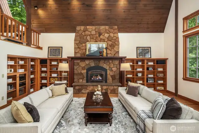 Custom built-ins, gas fireplace, dramatic stone hearth, reclaimed wood mantle.