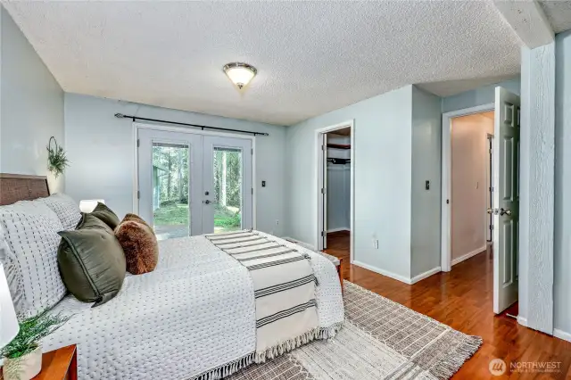 Primary bedroom wth french doors.