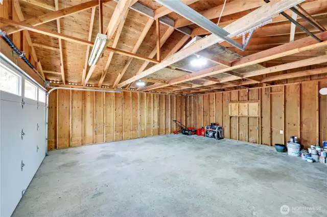 Spacious garage with new garage door.