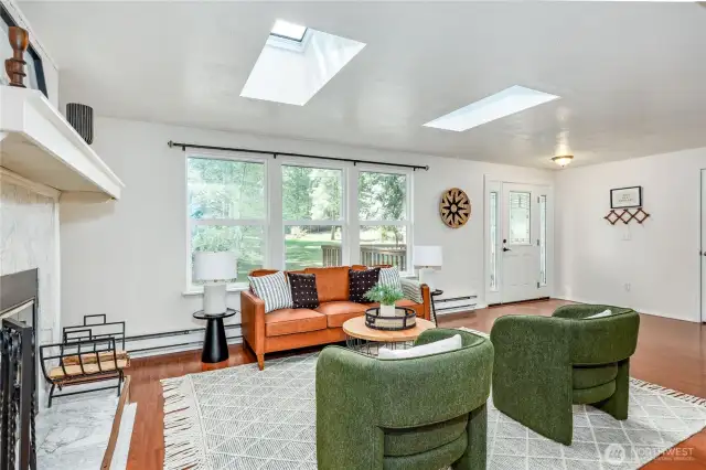 Living room with cozy fireplace, looking towards the front door.