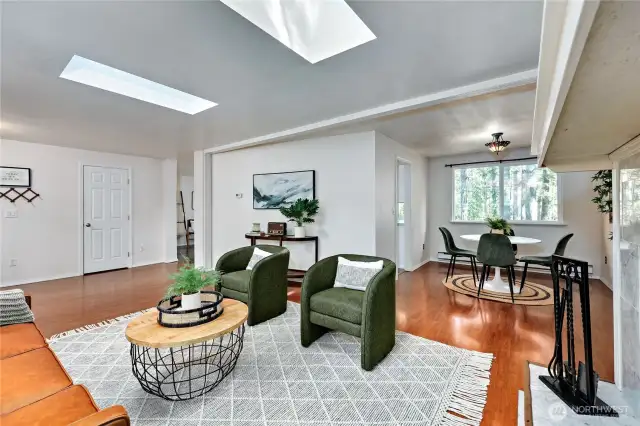 Skylights offer warm light, looking towards the dining room and kitchen.
