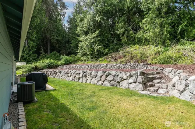 Tiered backyard which is ready for your ideas, plenty of area for gardening.