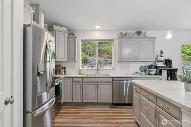 A kitchen where you can enjoy preparing meals. Soft pull cabinetry and take in the views.